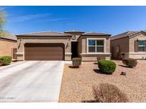 Beautiful single-story home featuring a two car garage and a well-maintained xeriscaped front yard at 36454 W Picasso St, Maricopa, AZ 85138