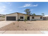 Charming single-story home featuring a low maintenance desert landscape and a large two car garage at 3752 W Becker Ln, Phoenix, AZ 85029