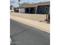 Charming single-story home featuring an attached garage, arched entryway, and desert-friendly landscaping at 5211 W Beryl Ave, Glendale, AZ 85302