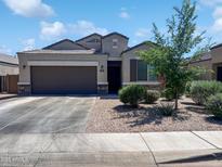Charming single-Gathering home featuring a two-car garage and well-manicured landscaping at 1237 E Paul Dr, Casa Grande, AZ 85122