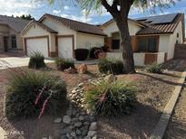 Charming home featuring a two-car garage, desert landscaping with decorative rocks at 15742 W Central St, Surprise, AZ 85374