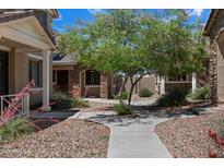Landscaped front yard with a charming home, stone facade, and inviting walkway at 17802 N 114Th Ln, Surprise, AZ 85378