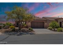 Charming single-story home showcasing a xeriscaped front yard, concrete driveway and a neutral-toned exterior paint at 1809 E Adelante Way, Queen Creek, AZ 85140