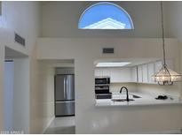 Bright kitchen features stainless steel appliances and modern lighting fixtures at 2100 W Lemon Tree Pl # 29, Chandler, AZ 85224
