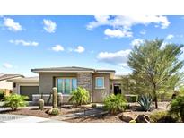 Charming home featuring desert landscaping including cactus and palm trees, enhanced by stone accents at 2821 E Cashman Dr, Phoenix, AZ 85050