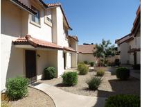 Charming condo community featuring terracotta tile roofs and well-maintained landscaping at 2927 N Oregon St # 7, Chandler, AZ 85225