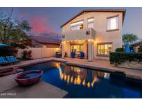 Inviting backyard with a pool and an outdoor seating area perfect for entertaining at 4038 E Wagon Cir, Gilbert, AZ 85297