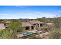 This home features a backyard with a private pool, spa, and mountain views at 41627 N Cedar Chase Rd, Anthem, AZ 85086