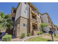 Inviting multi-story condo featuring stucco siding, landscaping, balconies, and a barbecue grill at 5302 E Van Buren St # 3040, Phoenix, AZ 85008