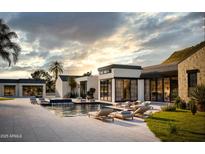 Stunning backyard oasis with a sparkling pool and comfortable lounge chairs, perfect for relaxation at 5636 E Caballo Dr, Paradise Valley, AZ 85253