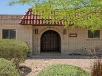 Charming brick home with a covered front entry and a striking, arched doorway at 7232 N 22 Nd St, Phoenix, AZ 85020