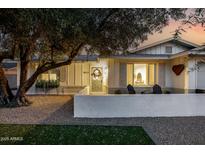 Charming home featuring a well-manicured lawn, a cozy front patio, and a welcoming front door with decorative wreath at 8021 N 16Th Dr, Phoenix, AZ 85021