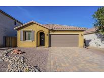 Charming single-story home featuring a paver driveway and low maintenance desert landscaping at 13140 W Rowel Rd, Peoria, AZ 85383