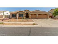 Charming single-story home featuring a tile roof and well-manicured desert landscaping at 16337 W Pierce St, Goodyear, AZ 85338