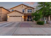 Charming two-story home featuring a well-manicured front yard, two car garage, and inviting front porch at 1721 E Cielo Grande Ave, Phoenix, AZ 85024