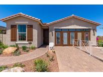 Charming single-story home with well-maintained landscaping and a welcoming front entrance at 17650 W Bajada Rd, Surprise, AZ 85387