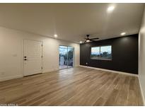 Bright living room with wood floors, ceiling fan, and sliding glass doors at 1916 W Morningside Dr # 111, Phoenix, AZ 85023
