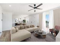 Bright living room featuring a modern ceiling fan and a sectional couch at 1916 W Morningside Dr # 111, Phoenix, AZ 85023