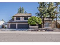 Charming two-story home featuring a three-car garage and a well-maintained front yard at 1927 E Ranch Rd, Tempe, AZ 85284