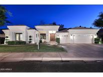 Elegant home exterior at dusk featuring manicured lawn, and a three car garage at 2041 W Hemlock Way, Chandler, AZ 85248