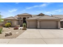 Charming home featuring a tile roof, three-car garage, and desert landscaping at 27953 N 111Th Way, Scottsdale, AZ 85262