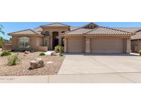Stunning single-story home boasting a spacious three-car garage and beautiful desert landscaping at 27953 N 111Th Way, Scottsdale, AZ 85262
