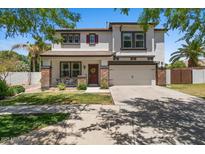 Charming two-story home featuring a well-manicured lawn, covered porch, and attached two-car garage at 3784 E Washington Ct, Gilbert, AZ 85234