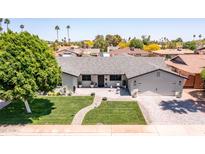 Beautiful home featuring a well manicured yard, updated roof, and brick driveway and walkway at 5919 S Newberry Rd, Tempe, AZ 85283