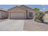 Charming home featuring a two-car garage and a xeriscaped front yard at 8733 W Laurel Ln, Peoria, AZ 85345