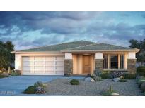 Charming single-story home showcasing stone accents, a two-car garage, and desert landscaping at 10909 S 52Nd Dr, Laveen, AZ 85339