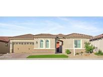 Charming home features desert landscaping, a two-car garage, and a tiled roof at 19045 N 269Th Dr, Buckeye, AZ 85396