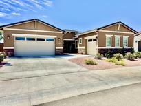 Charming single-story home with a three-car garage and well-manicured front yard at 20171 W Cheery Lynn Rd, Buckeye, AZ 85396