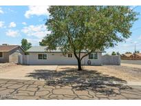 Charming single-story home featuring a mature tree, driveway and landscaping in a desirable neighborhood at 2395 S Arizona Rd, Apache Junction, AZ 85119
