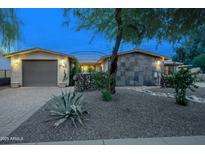 Charming single-story home featuring desert landscaping, stone accents, and a two-car garage at 4008 N 85Th St, Scottsdale, AZ 85251