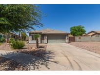 Charming single-story home with desert landscaping, neutral colors, and a two-car garage, offering curb appeal at 4100 S Dewdrop Ct, Gilbert, AZ 85297