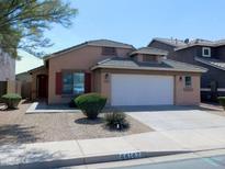 Charming single-Gathering home featuring desert landscaping and a two-car garage at 44147 W Snow Dr, Maricopa, AZ 85138