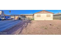 View of the house featuring a covered driveway and desert landscaping in the front yard at 4727 N 50Th Dr, Phoenix, AZ 85031