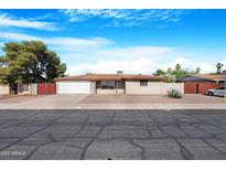 Charming single-story home with a well-maintained front yard and attached two-car garage at 612 N Recker Rd, Mesa, AZ 85205