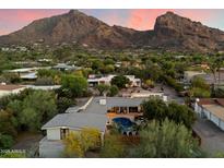 Stunning aerial view of a modern home with a pool and mountain views at 6417 N 52Nd Pl, Paradise Valley, AZ 85253
