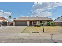 Charming single-story home with a well-maintained front yard, complemented by a two-car garage and inviting curb appeal at 7125 W Canterbury Dr, Peoria, AZ 85345