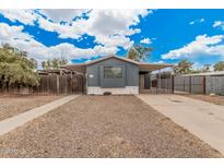 Charming single-story home with neutral-toned exterior, gravel landscaping, and gated entrance at 8107 E Butte St, Mesa, AZ 85207