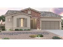 Charming single-story home featuring stone accents, neutral color palette, and a well-manicured desert landscape at 8746 S 168Th Ave, Goodyear, AZ 85338