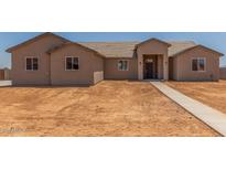 Tan single story house with tile roof and covered front porch, new construction at 9485 W Sandstone Mountain Dr, Casa Grande, AZ 85194