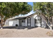 Charming single-story home with a well-maintained front yard and mature trees providing shade at 1098 E Fremont Dr, Tempe, AZ 85282