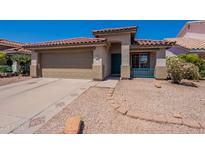 Inviting single-story home featuring a red tile roof, low maintenance landscaping, and a two-car garage at 12208 N 41St Ln, Phoenix, AZ 85029