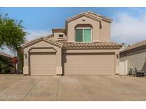 Charming home featuring a three-car garage and a beautifully tiled roof at 13993 N 102Nd St, Scottsdale, AZ 85260
