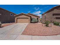 Charming single-story home features a two-car garage and desert landscaping for easy maintenance at 14244 N 132Nd Ln, Surprise, AZ 85379