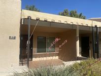 Charming front porch with a small awning, desert landscaping and a secure front door at 14300 W Bell Rd # 57, Surprise, AZ 85374