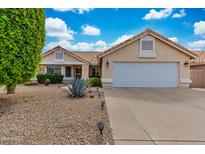 Charming single-story home with a well-maintained desert landscaped front yard and a two-car garage at 16230 E Glenpoint Dr, Fountain Hills, AZ 85268
