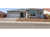 Charming single-story home featuring a two-car garage, desert landscaping, and a welcoming front entrance at 20274 W Monterey Way, Buckeye, AZ 85396